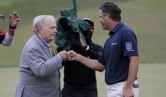 Ryan Palmer, right, fist bumps Jack Nicklaus after the final round of the Memorial golf tournament, Sunday, July 19, 2020, in Dublin, Ohio. (AP Photo/Darron Cummings)