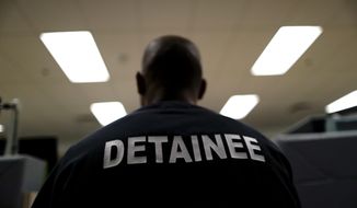 In this file photho, a detainee sits at the Otay Mesa Detention Center Wednesday, Aug. 23, 2017, in San Diego. (AP Photo/Gregory Bull)  **FILE**