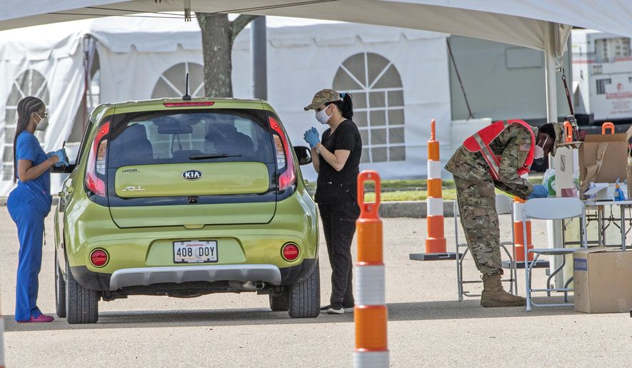 People line up at the Covid-19 testing site at the Southern University's FG Clark parking lot, Tuesday July 7, 2020, in Baton Rouge, La. (Bill Feig/The Advocate via AP)