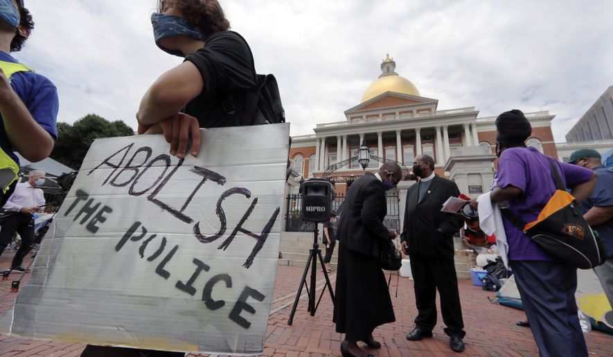 People gather for a protest outside the Statehouse, Monday, July 20, 2020, in Boston, on a day when thousands across the country planned to walked off the job to protest systemic racism and economic inequality that has worsened during the coronavirus pandemic. (AP Photo/Charles Krupa)