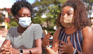 Members of the Wofford Anti-Racism Coalition, including Destiny Shippy, left, and Naya Taylor, right, talk about some of their grievances with Wofford College, in Spartanburg, S.C., Thursday, July 9, 2020. (Tim Kimzey/Spartanburg Herald-Journal via AP)