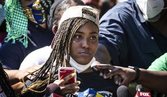 Miracle Boyd, 18, an activist with GoodKids MadCity, speaks during a press conference in front of a statue of President George Washington near East 51st Street and South King Drive, describing a recent violent encounter she had with Chicago Police, Monday morning, July 20, 2020. Boyd was participating in a Friday evening protest against a statue of Christopher Columbus in Grant Park, when she alleges she had several teeth knocked out by a Chicago Police officer. (Ashlee Rezin Garcia/Chicago Sun-Times via AP)