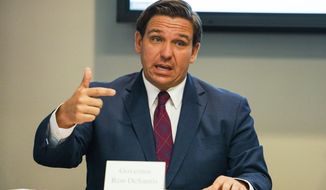 Florida Gov. Ron DeSantis answers questions during a roundtable discussion held alongside First Lady Casey DeSantis, regarding mental health and COVID-19 at the Tampa Bay Crisis Center on Thursday, July 16, 2020 in Tampa. (Martha Asencio-Rhine/Tampa Bay Times via AP)