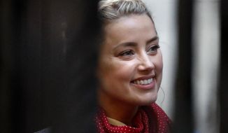 U.S. Actress Amber Heard arrives at the High Court in London, Tuesday, July 21, 2020. Actor Johnny Depp is suing News Group Newspapers, publisher of The Sun, and the paper&#39;s executive editor, Dan Wootton, over an April 2018 article that called him a &amp;quot;wife-beater.&amp;quot;  Depp strongly denies all allegations.(AP Photo/Frank Augstein)