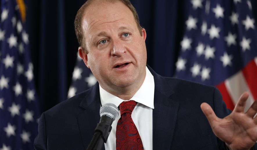 Colorado Governor Jared Polis makes a point during a news conference on the state's efforts against the new coronavirus Tuesday, July 21, 2020, in Denver. (AP Photo/David Zalubowski)