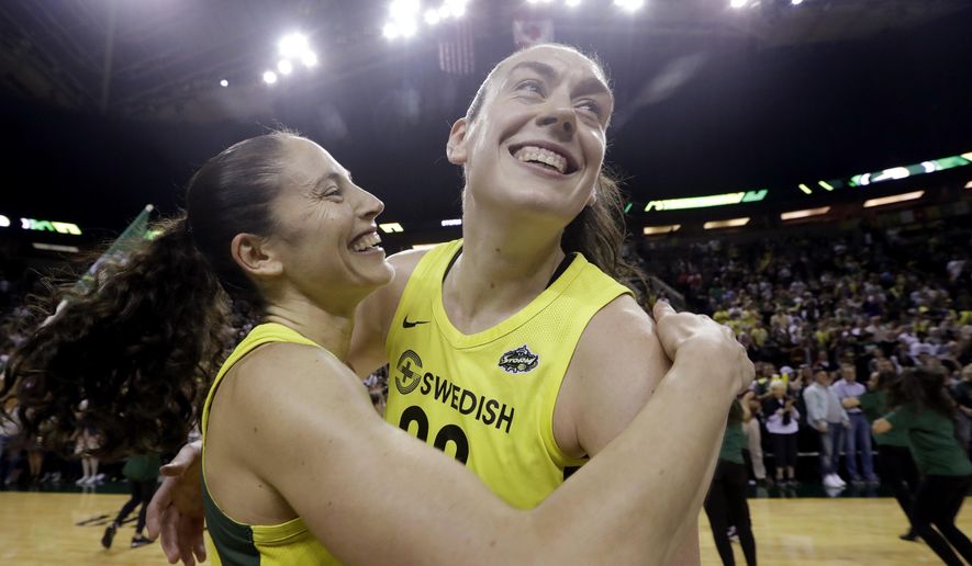 FILE - This Sept. 4, 2018, file photo shows Seattle Storm's Sue Bird, left, and Breanna Stewart embracing after the Storm defeated the Phoenix Mercury 94-84 during Game 5 of a WNBA basketball playoff semifinal, in Seattle. With Breanna Stewart and Sue Bird back, the Seattle Storm are healthy to begin the season and sit atop the preseason Associated Press WNBA poll. The Storm were the unanimous choice receiving all 16 first-place votes from the national media panel Tuesday, July 21, 2020. (AP Photo/Elaine Thompson, File)