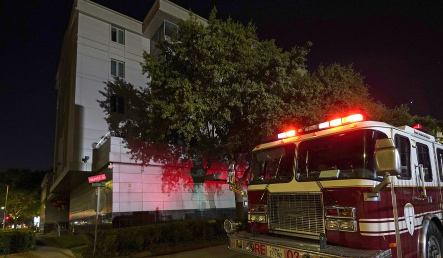 A firetruck is positioned outside the Chinese Consulate Wednesday, July 22, 2020, in Houston. Authorities responded to reports of a fire at the consulate. Witnesses said that people were burning paper in what appeared to be trash cans, according to police. China says the U.S. has ordered it to close its consulate in Houston in what it called a provocation that violates international law. (AP Photo/David J. Phillip)