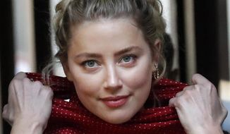 US actress Amber Heard arrives at the High Court in London in London, Wednesday, July 22, 2020. Actor Heard&#39;s ex-husband Johnny Depp is suing News Group Newspapers, publisher of The Sun, and the paper&#39;s executive editor, Dan Wootton, over an April 2018 article that called him a &amp;quot;wife-beater.&amp;quot; Depp strongly denies all allegations. (AP Photo/Frank Augstein)