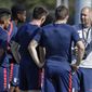 FILE - In this Wednesday, Jan. 8, 2020, file photo, Gregg Berhalter, right, head coach of the U.S. Men&#39;s National Soccer team, instructs some of his players during drills in Bradenton, Fla. The fallout of the coronavirus pandemic could benefit the U.S. soccer team when World Cup qualifying begins in North and Central America and the Caribbean. “If we go to qualifying in empty stadiums, that’s going to change that dynamic considerably, some for the positive and some for the worse,” Berhalter said Tuesday, July 21, 2020. (AP Photo/Chris O&#39;Meara, File)