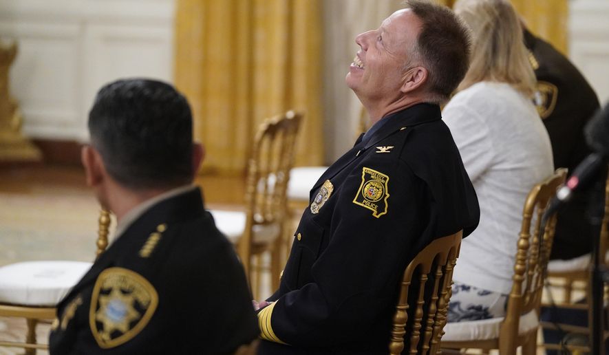 Bernalillo County Sheriff Manuel Gonzales, left, and Kansas City police Chief Rick Smith, second from left, wait for an event on "Operation Legend: Combatting Violent Crime in American Cities," to begin in the East Room of the White House, Wednesday, July 22, 2020, in Washington. (AP Photo/Evan Vucci)