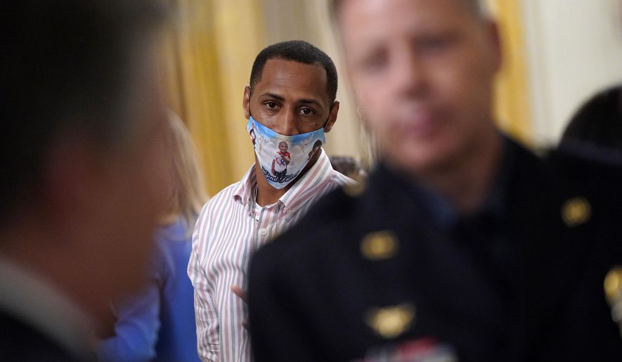 LeGend Taliferro's father Raphael Taliferro attends an event on "Operation Legend: Combatting Violent Crime in American Cities," in the East Room of the White House, Wednesday, July 22, 2020, in Washington. (AP Photo/Evan Vucci)