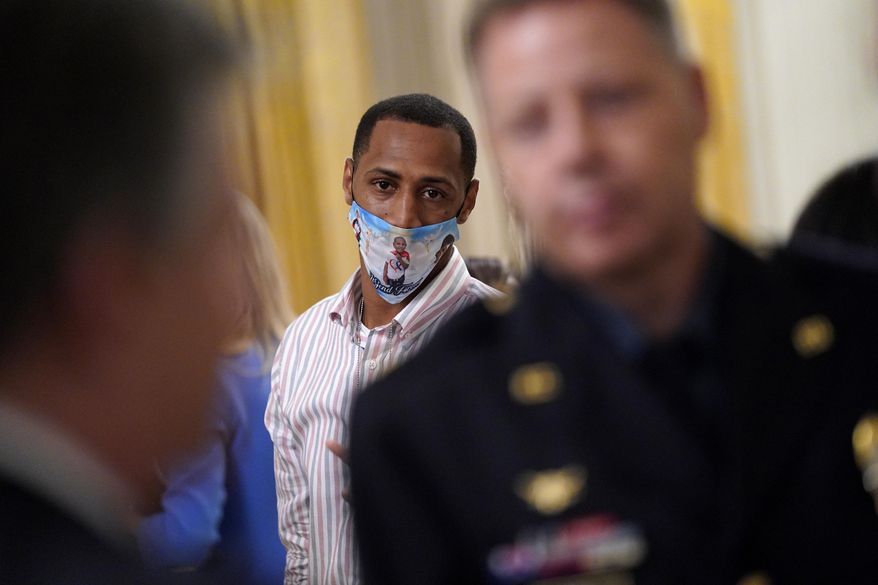 LeGend Taliferro's father Raphael Taliferro attends an event on "Operation Legend: Combatting Violent Crime in American Cities," in the East Room of the White House, Wednesday, July 22, 2020, in Washington. (AP Photo/Evan Vucci)