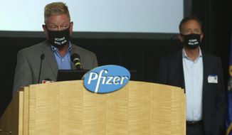 John Burkhardt, left, senior vice president of drug safety R&amp;amp;D and head of the Pfizer Groton site speaks at a press conference at Pfizer Groton on the companies research to develop a vaccine for COVID-19, as Connecticut Gov. Ned Lamont stands by to answer questions Wednesday, July 22, 2020, in Groton, Conn. The federal government has agreed to pay nearly $2 billion for 100 million doses of a potential COVID-19 vaccine being developed by the U.S. drugmaker and its German partner BioNTech. (AP Photo/Stew Milne)