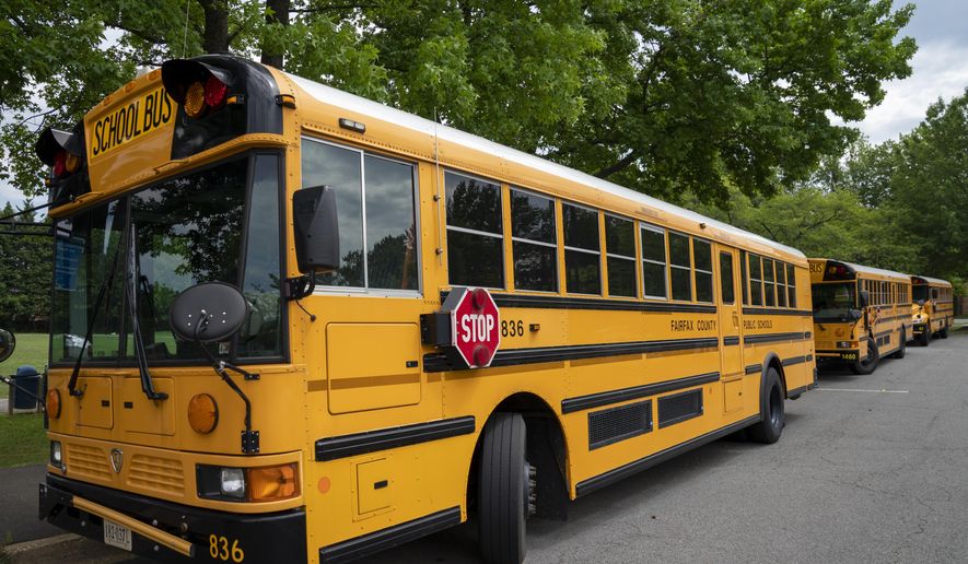 Fairfax County Public School buses parked at a middle school in Falls Church, Va., on Monday, July 20, 2020 (AP Photo/J. Scott Applewhite) **FILE**