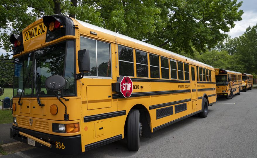 Fairfax County Public School buses parked at a middle school in Falls Church, Va., on Monday, July 20, 2020 (AP Photo/J. Scott Applewhite) **FILE**