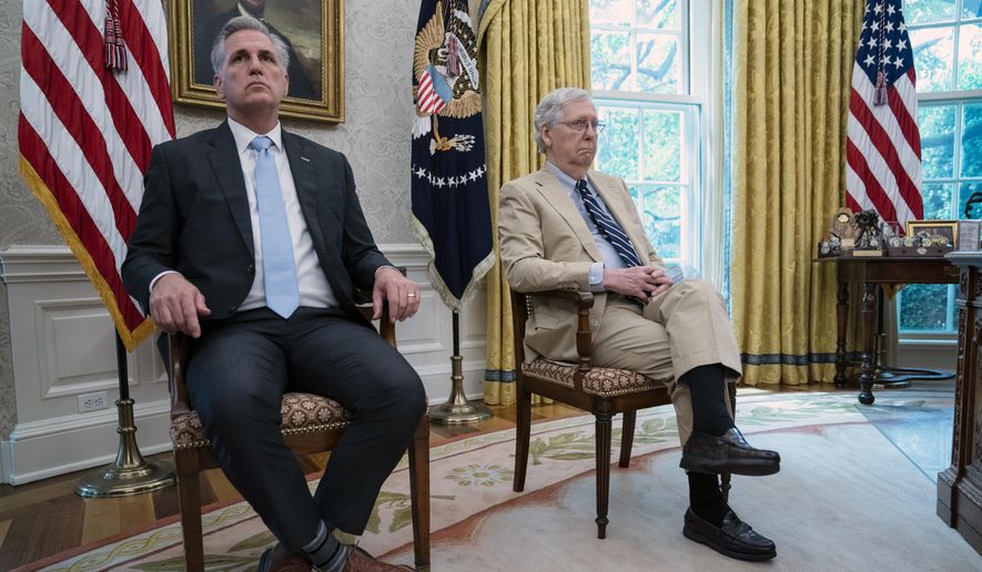 Senate Majority Leader Mitch McConnell of Ky., right, and House Minority Leader Kevin McCarthy of Calif., listen as President Donald Trump speaks during a meeting in the Oval Office of the White House, Monday, July 20, 2020, in Washington. Congress is just starting to negotiate new legislation to renew coronavirus aid. But the biggest obstacles to a deal are already coming into view. The Democratic House passed a whopping $3.5 trillion coronavirus response bill more than two months ago and is demanding robust funding to help state and local governments. Republicans want to keep the bill closer to $1 trillion and are insisting on new legal protections for schools, businesses, and charities that are trying to reopen. It’s up to top congressional leaders to bridge the gaps as they negotiate with President Donald Trump&#39;s White House.  (AP Photo/Evan Vucci)