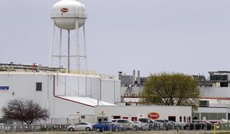 FILE - This April 16, 2020 file photo shows the Tyson Foods pork processing plant in Columbus Junction, Iowa. One of the first coronavirus outbreaks at the Iowa meatpacking plant was more severe than previously known, with over twice as many workers becoming infected than the Iowa Department of Public Health publicly confirmed.  The department announced at a May 5 news conference that 221 employees at the plant in Columbus Junction had tested positive for COVID-19. But records show that, days earlier, Tyson officials told workplace safety regulators that 522 plant employees had tested positive to their knowledge. (Jim Slosiarek/The Gazette via AP, File)
