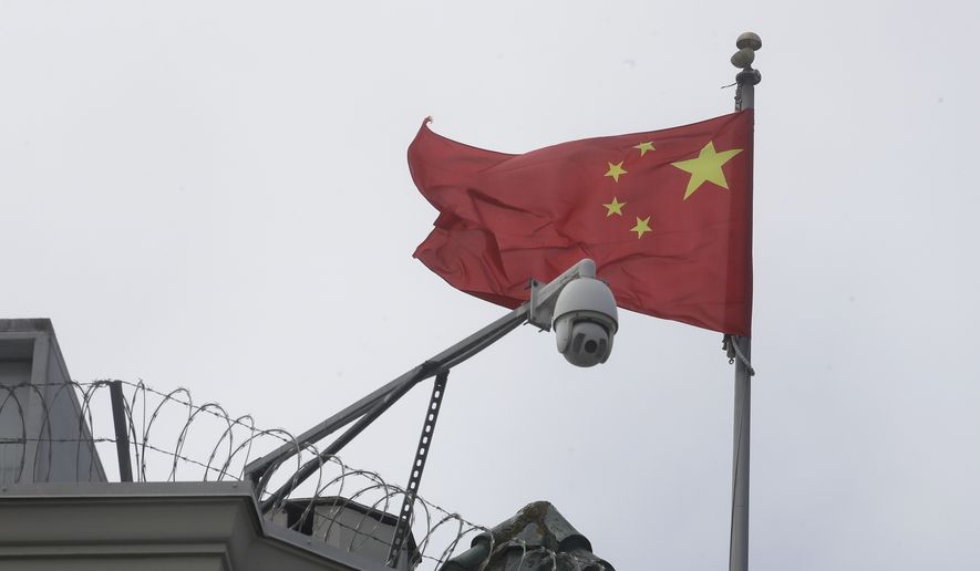 The flag of China flies behind a security camera over the Chinese Consulate in San Francisco, Thursday, July 23, 2020. San Francisco&#39;s government raised the Chinese flag over city hall (not pictured) last week to mark the founding of the People&#39;s Republic of China 73 years ago. (AP Photo/Jeff Chiu)