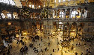 Visitors walk inside the Byzantine-era Hagia Sophia, in the historic Sultanahmet district of Istanbul, Friday, Oct. 15, 2010. Turkish President Recep Tayyip Erdogan is scheduled to join hundreds of worshipers Friday, July 24, 2020, for the first Muslim prayers at the Hagia Sophia in 86 years, weeks after a controversial high court ruling paved the way for the landmark monument to be turned back into a mosque. (AP Photo/Emrah Gurel)