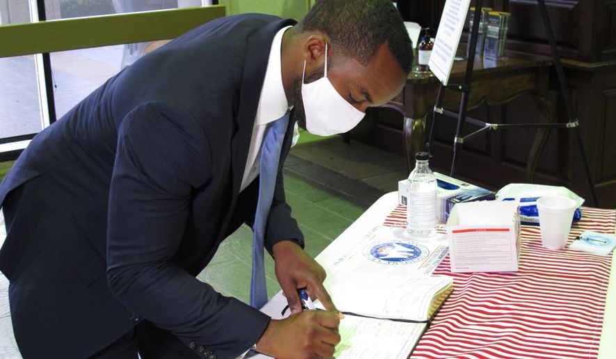 Shreveport Mayor Adrian Perkins, a Democrat, signs the registration book as he qualified for the U.S. Senate race, on Thursday, July 23, 2020, in Baton Rouge, La. Perkins is challenging Republican incumbent Bill Cassidy for the Senate seat. (AP Photo/Melinda Deslatte)