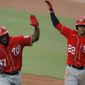 Washington Nationals&#39; Howie Kendrick (47) is greeted with &amp;quot;air high fives&amp;quot; by Juan Soto (22) after Kendrick scored them both on a two-run home run off Baltimore Orioles starting pitcher Alex Cobb during an exhibition baseball game, Monday, July 20, 2020, in Baltimore. (AP Photo/Julio Cortez)