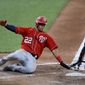 Washington Nationals&#39; Juan Soto, left, slides in ahead of a tag by Baltimore Orioles catcher Austin Wynns while scoring on a double by Howie Kendrick during an exhibition baseball game Monday, July 20, 2020, in Baltimore. (AP Photo/Julio Cortez) ** FILE **