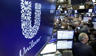 FILE - In this Thursday, March 15, 2018 file photo, the logo for Unilever appears above a trading post on the floor of the New York Stock Exchange.  Consumer products giant Unilever, said Thursday July 23, 2020, that second-quarter sales were only slightly lower than the same period a year ago despite the lockdown measures triggered by the global fight against the coronavirus.(AP Photo/Richard Drew, File)