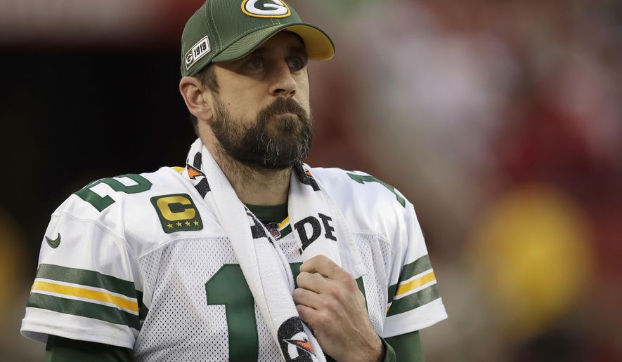 FILE - In this Jan. 19, 2020, file photo, Green Bay Packers quarterback Aaron Rodgers (12) watches from the sideline during the first half of the NFL NFC Championship football game against the San Francisco 49ers in Santa Clara, Calif. Some players surely flourished and others most certainly floundered when the COVID-19 crisis forced teams to replace their regular offseason programs with virtual OTAs and videoconference. (AP Photo/Ben Margot, File)