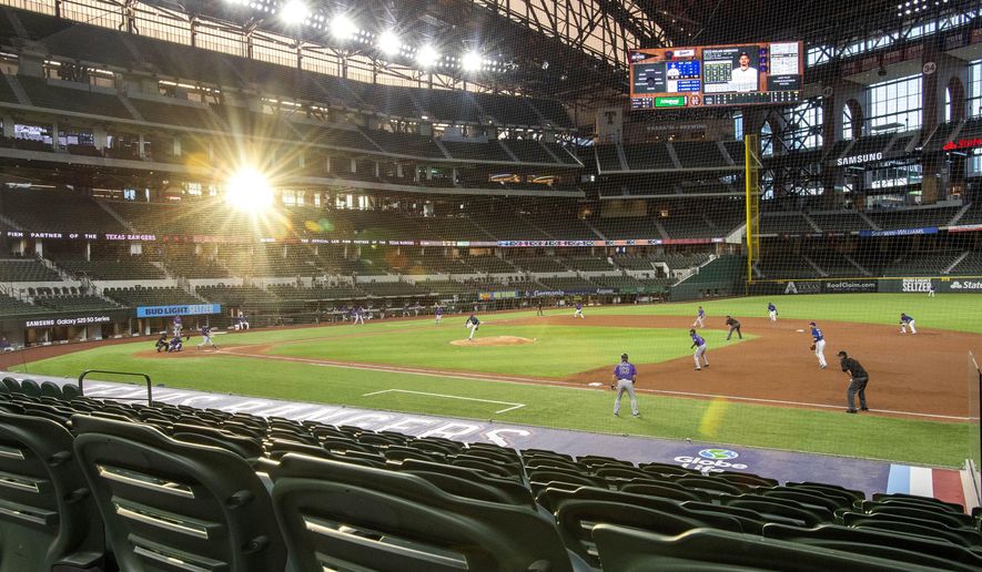 The setting sun shines through the windows of Globe Life Field during the third inning of a baseball game between the Texas Rangers and the Colorado Rockies Wednesday, July 22, 2020, in Arlington, Texas. (AP Photo/Jeffrey McWhorter)