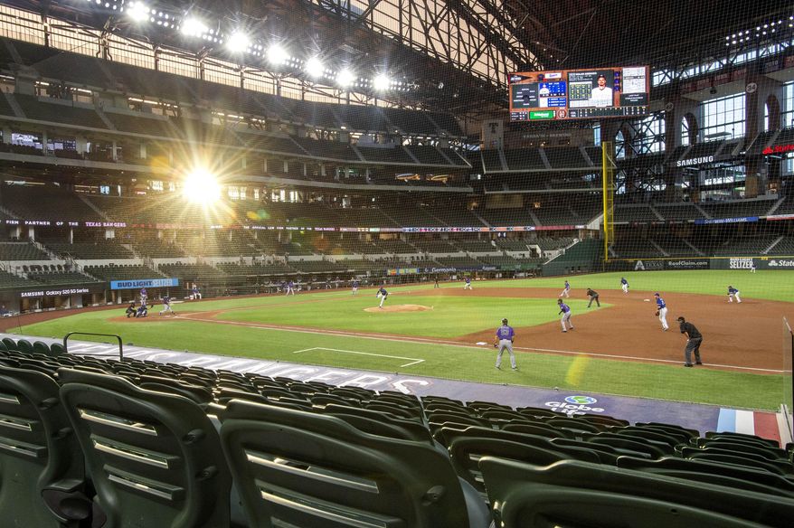 The setting sun shines through the windows of Globe Life Field during the third inning of a baseball game between the Texas Rangers and the Colorado Rockies Wednesday, July 22, 2020, in Arlington, Texas. (AP Photo/Jeffrey McWhorter)