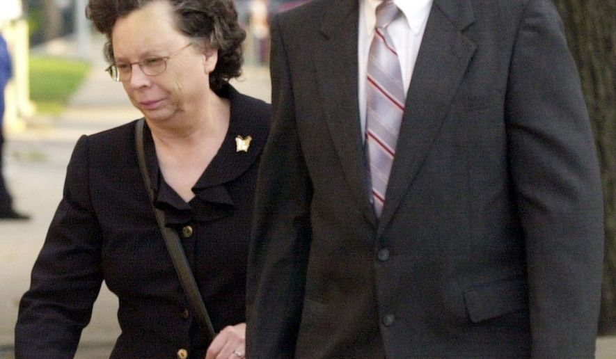 FILE - In this Oct. 5, 2005 file photo, Arlan and Linda Kaufman walk to the federal courthouse in Wichita, Kan., for their trial on several federal charges including servitude. A federal judge has refused to free Arlan Kaufman who once enslaved mentally ill patients in Kansas and forced them to work naked and engage in sexual acts, while billing the government and their families for the therapy. U.S. District Judge J. Thomas Marten cited the "particularly heinous nature" of the abusive treatment of mentally ill patients in a ruling Tuesday, July 21, 2020, to deny the request of Kaufman for compassionate release from his 30-year prison sentence amid the COVID-19 pandemic. (Dave Williams/The Wichita Eagle via AP)