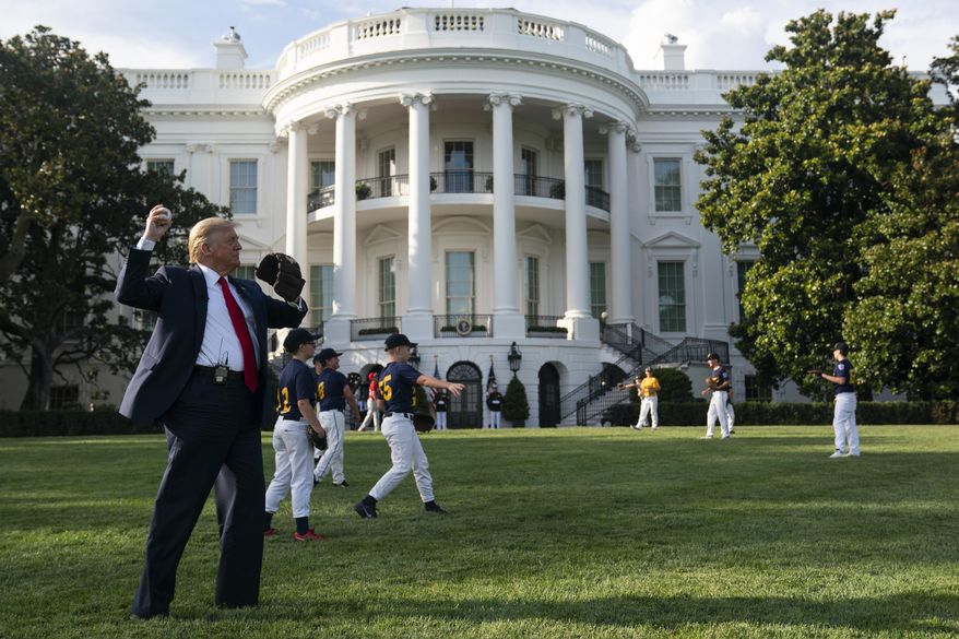 President Donald Trump plays catch with former New York Yankees Hall of Fame pitcher Mariano Rivera as he greets youth baseball players on the South Lawn of the White House to mark Opening Day for Major League Baseball, Thursday, July 23, 2020, in Washington. (AP Photo/Evan Vucci)