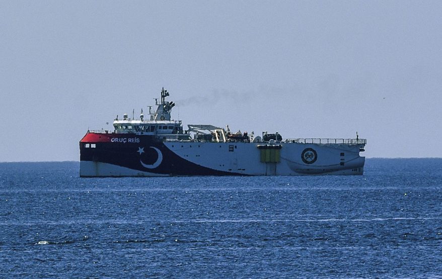 In this photograph taken from the Mediterranean shores near the city of Antalya, Turkey, a view of the research vessel Oruc Reis, Wednesday, July 22, 2020. Turkey rejected claims by Greece that its oil-and-gas research vessels were encroaching on Greek territory in the eastern Mediterranean and said it would continue to defend its legitimate rights and interests in the region. But a Foreign Ministry statement issued Wednesday also renewed a call by Ankara for dialogue to resolve the dispute between the two NATO allies. (Semih Ersozler/DHA via AP)