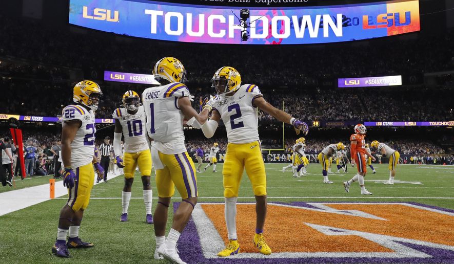 FILE - In this Jan. 13, 2020, file photo, LSU wide receiver Ja'Marr Chase (1) celebrates after scoring with wide receiver Justin Jefferson during the first half of a NCAA College Football Playoff national championship game against Clemson in New Orleans. There are more bowl games scheduled for the coming season than ever before in major college football: 42, not including the College Football Playoff championship. College football leaders are in the process of piecing together plans to attempt to play a regular season during the COVID-19 pandemic. If it is even possible, everyone anticipates there will be disruptions, added expenses and loads of stress just to get through it. (AP Photo/Gerald Herbert, File)