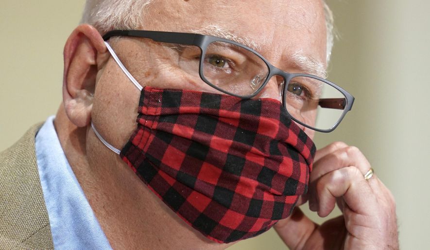 Minnesota Gov. Tim Walz wore his buffalo plaid cloth mask during questions at a press conference to announce statewide mask mandate Wednesday, July 22, 2020, to help slow the spread of COVID-19. (Anthony Souffle/Star Tribune via AP)