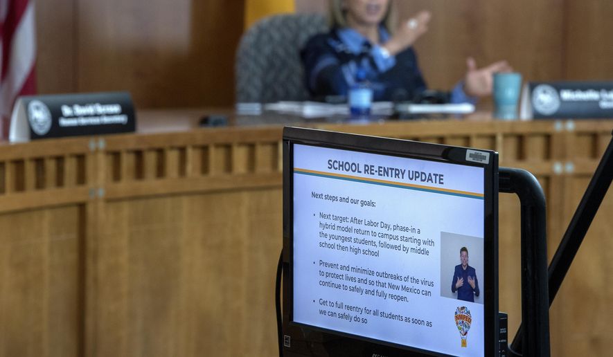 New Mexico Gov. Michelle Lujan Grisham announces public schools must go to a distance-learning program to start the school year. She made the announcement during an update on COVID-19 broadcast from the state Capitol in Santa Fe, N.M., on Thursday, July 23, 2020. (Eddie Moore/The Albuquerque Journal via AP)