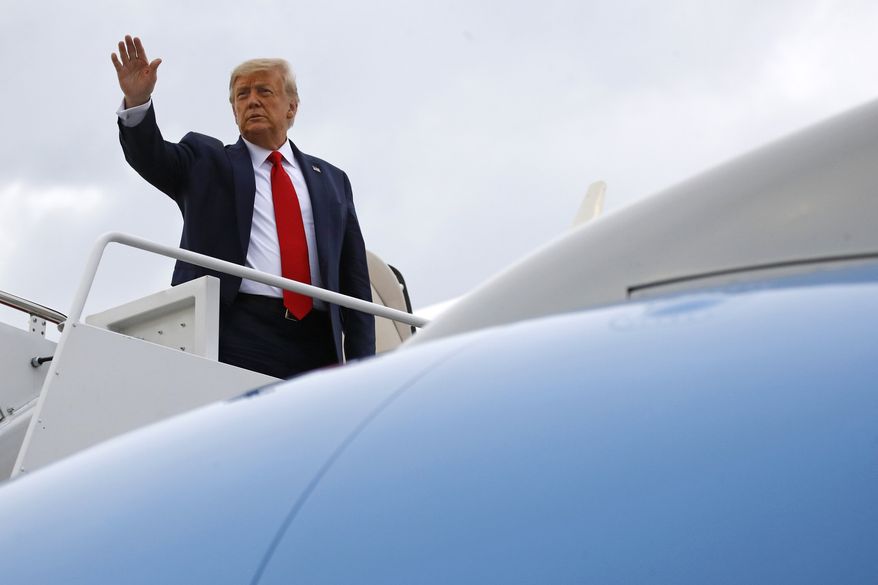 President Donald Trump waves as he boards Air Force One at Andrews Air Force Base, Md., Friday, July 24, 2020. Trump is spending the weekend at his golf club in New Jersey. (AP Photo/Patrick Semansky)