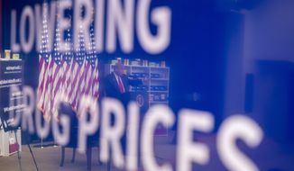 President Donald Trump is reflected in a television monitor as he speaks during an event to sign executive orders on lowering drug prices, in the South Court Auditorium in the White House complex, Friday, July 24, 2020, in Washington. (AP Photo/Alex Brandon)