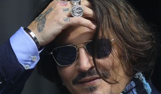 Actor Johnny Depp arrives at the High Court for a hearing in his libel case, in London, Friday,  July 24, 2020. Depp is suing News Group Newspapers, publisher of The Sun, and the paper&#39;s executive editor, Dan Wootton, over an April 2018 article that called him a &amp;quot;wife-beater.&amp;quot; The Sun&#39;s defense relies on a total of 14 allegations by his ex-wife, actress Amber Heard of Depp&#39;s violence. He strongly denies all of them. (Aaron Chown/PA via AP)