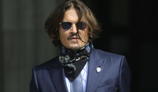 Actor Johnny Depp arrives at the High Court for a hearing in his libel case, in London, Friday,  July 24, 2020. Depp is suing News Group Newspapers, publisher of The Sun, and the paper&#39;s executive editor, Dan Wootton, over an April 2018 article that called him a &amp;quot;wife-beater.&amp;quot; The Sun&#39;s defense relies on a total of 14 allegations by his ex-wife, actress Amber Heard of Depp&#39;s violence. He strongly denies all of them. (Aaron Chown/PA via AP)
