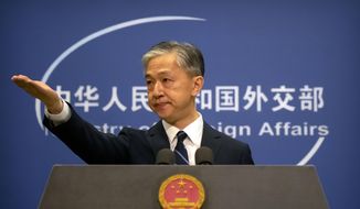 China&#39;s Ministry of Foreign Affairs spokesperson Wang Wenbin gestures during a daily briefing at the Ministry of Foreign Affairs in Beijing, Friday, July 24, 2020. (AP Photo/Mark Schiefelbein)