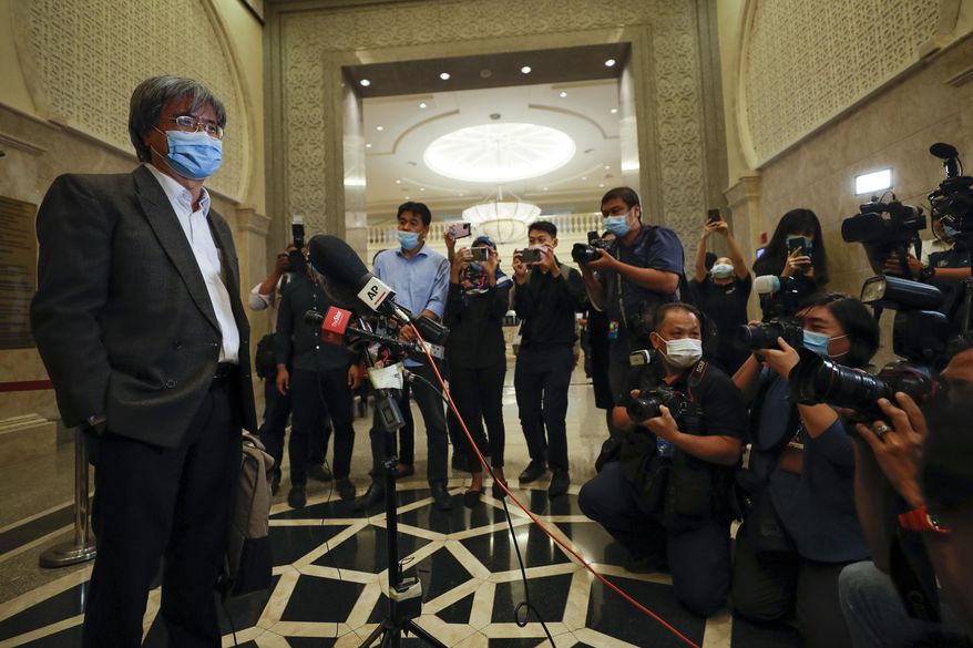 In this picture taken Thursday, July 2, 2020, show Steven Gan, left, editor-in-chief of Malaysiakini online news portal arrive at court in Putrajaya, Malaysia, Monday, July 13, 2020. Attorney General Idrus Harun, who was appointed by a new government that took power in March, filed contempt proceedings against Malaysiakini and Gan over comments made by five readers on its portal last month that allegedly tarnished the judiciary. (AP Photo/Vincent Thian)