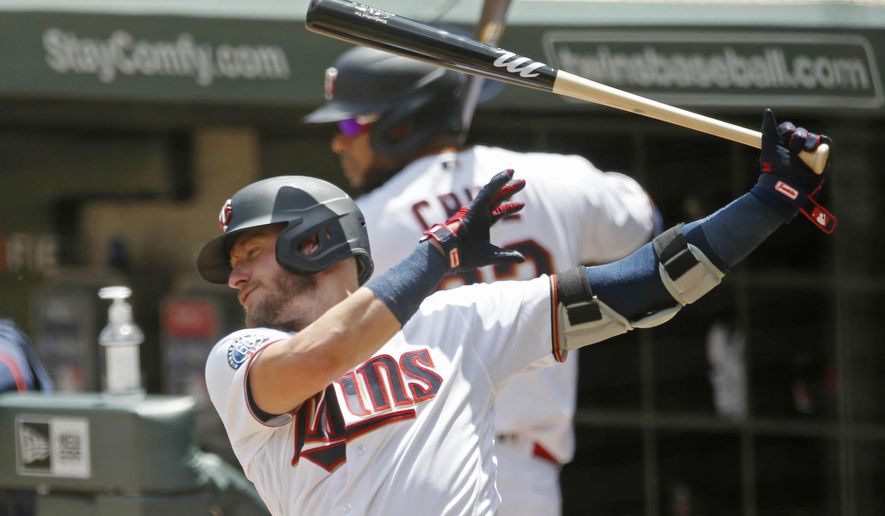 Minnesota Twins' Josh Donaldsonn, left, takes a practice swing on deck along with Nelson Cruz during a summer camp intrasquad baseball game Friday, July 17, 2020 in Minneapolis. (AP Photo/Jim Mone)