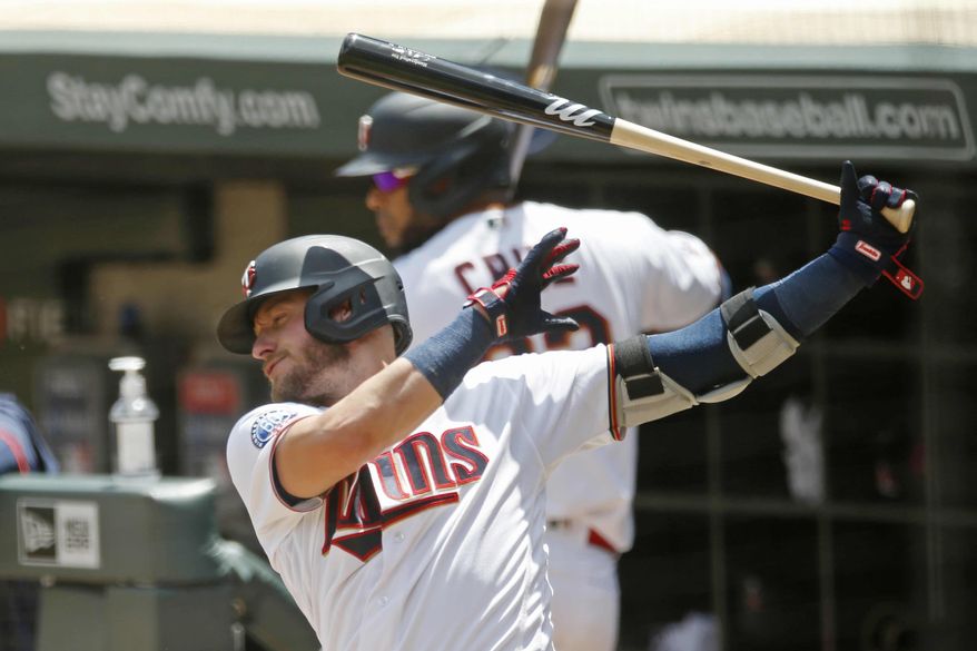 Minnesota Twins' Josh Donaldsonn, left, takes a practice swing on deck along with Nelson Cruz during a summer camp intrasquad baseball game Friday, July 17, 2020 in Minneapolis. (AP Photo/Jim Mone)