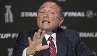 In this May 27, 2019, file photo, NHL Commissioner Gary Bettman speaks to the media before Game 1 of the NHL hockey Stanley Cup Final between the St. Louis Blues and the Boston Bruins in Boston. Bettman said getting to those quarantined bubbles and resuming play are just two more steps in the process with the goal of awarding the Stanley Cup in late September or early October. (AP Photo/Charles Krupa, File)  **FILE**