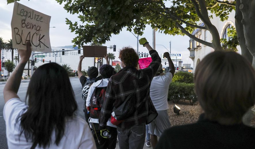 People march during a Black Lives Matter protest near UNLV, Tuesday, June 2, 2020, in Las Vegas. Top administrators at UNLV say they'll act on recommendations from an Anti-Black Racism Task Force formed in June to address social unrest following the death of George Floyd in police custody in Minnesota. (Chase Stevens/Las Vegas Review-Journal via AP)