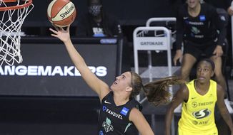 New York Liberty forward Sabrina Ionescu goes up for a shot as Seattle Storm guard Jewell Loyd, right, watches during the second half of a WNBA basketball game, Saturday, July 25, 2020, in Ellenton, Fla. (AP Photo/Phelan M. Ebenhack)