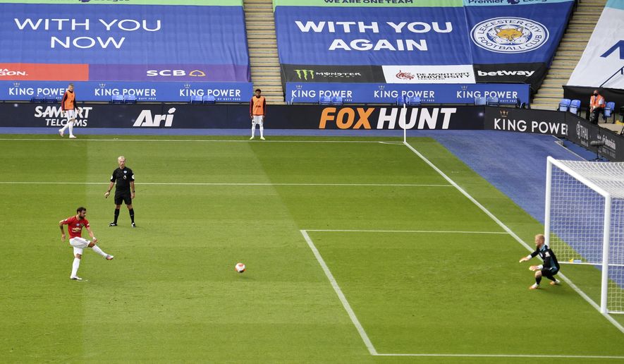 Manchester United&#x27;s Bruno Fernandes, left, scores his side&#x27;s opening goal from the penalty spot during the English Premier League soccer match between Leicester City and Manchester United at the King Power Stadium, in Leicester, England, Sunday, July 26, 2020. (Oli Scarff/Pool via AP)