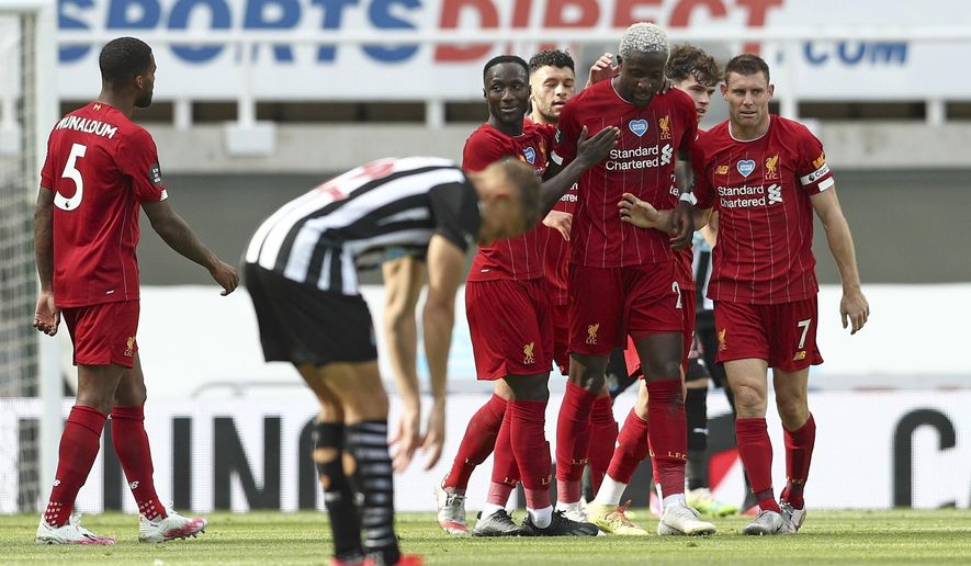 Liverpool's Divock Origi, second right, celebrates after scoring his side's second goal during the English Premier League soccer match between Newcastle and Liverpool at St. James' Park in Newcastle, England, Sunday, July 26, 2020. (Jan Kruger, Pool via AP)