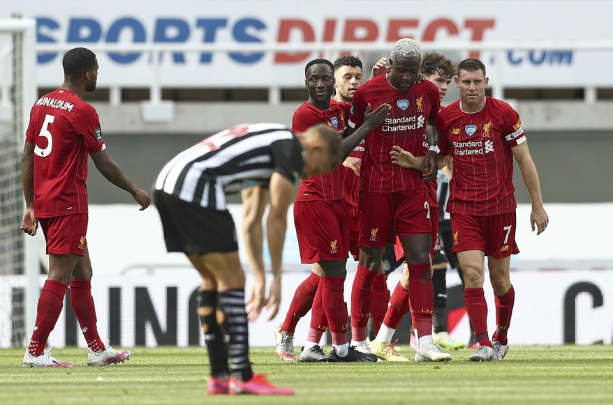 Liverpool's Divock Origi, second right, celebrates after scoring his side's second goal during the English Premier League soccer match between Newcastle and Liverpool at St. James' Park in Newcastle, England, Sunday, July 26, 2020. (Jan Kruger, Pool via AP)